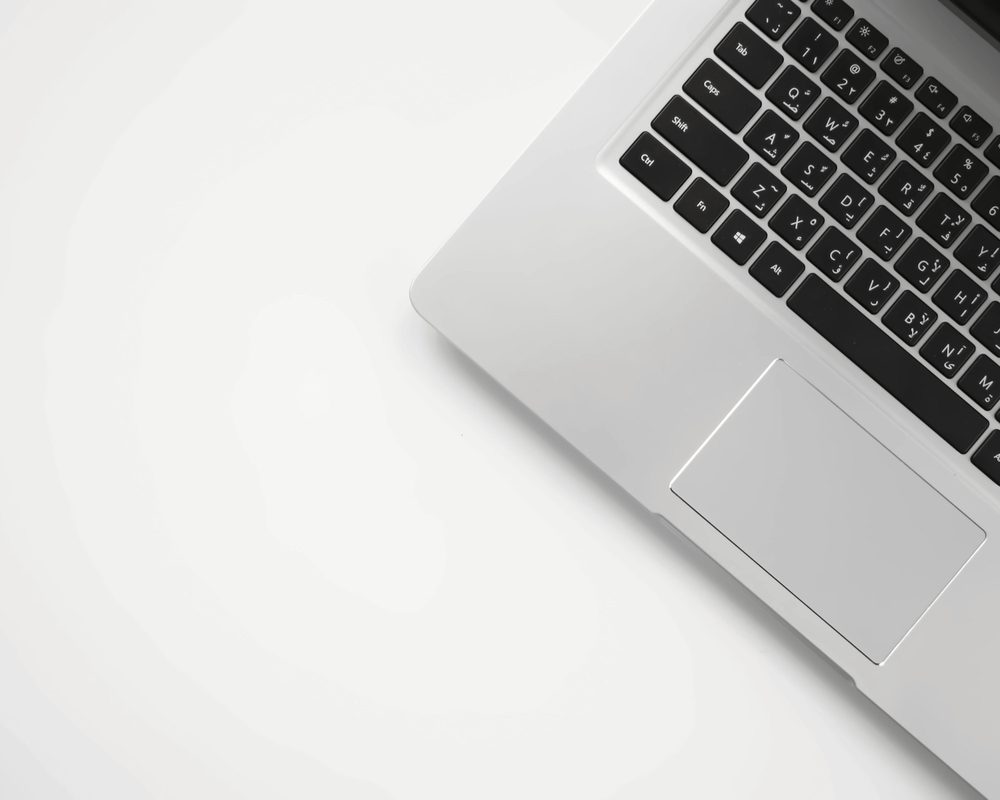 White laptop on a clean desk, pick a plan